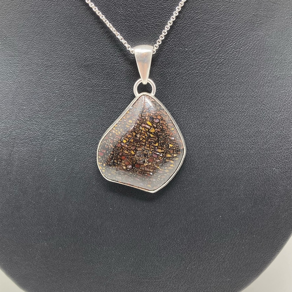 Handmade agatized dinosaur bone silver pendant